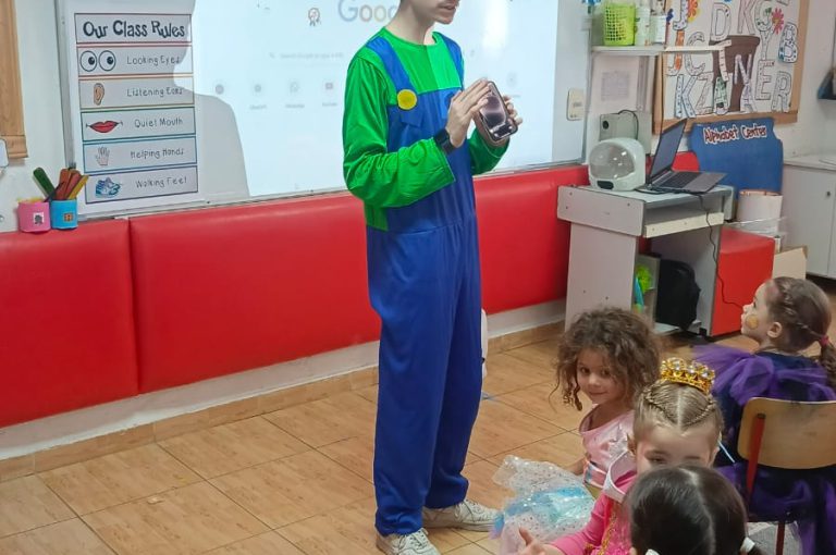 “IB DP Year 1 students from LWIS-AiS celebrating Halloween with KG1–KG3 children through crafts, games, and storytelling – fostering creativity, empathy, and service.”