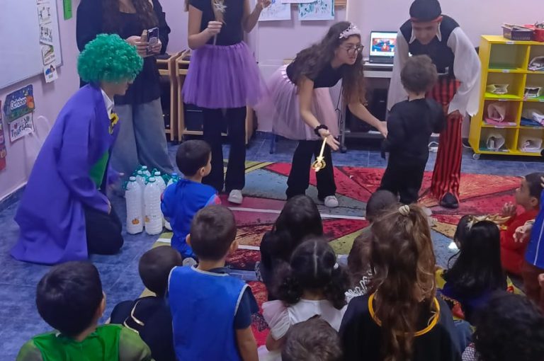 “IB DP Year 1 students from LWIS-AiS celebrating Halloween with KG1–KG3 children through crafts, games, and storytelling – fostering creativity, empathy, and service.”