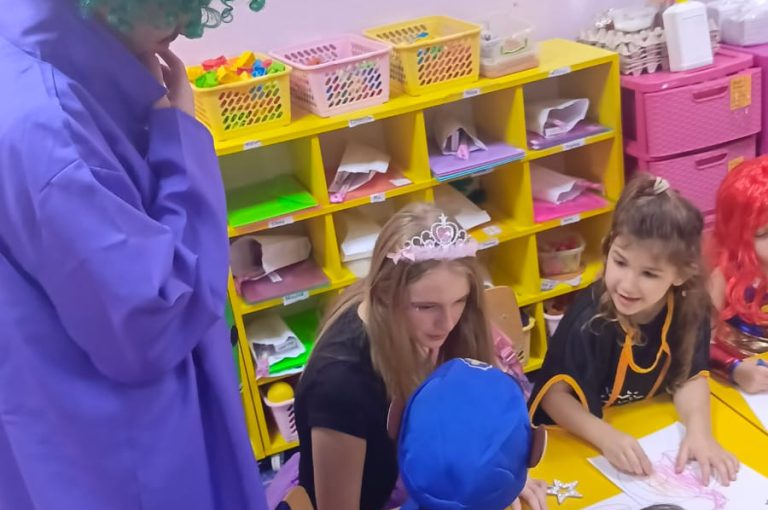 “IB DP Year 1 students from LWIS-AiS celebrating Halloween with KG1–KG3 children through crafts, games, and storytelling – fostering creativity, empathy, and service.”