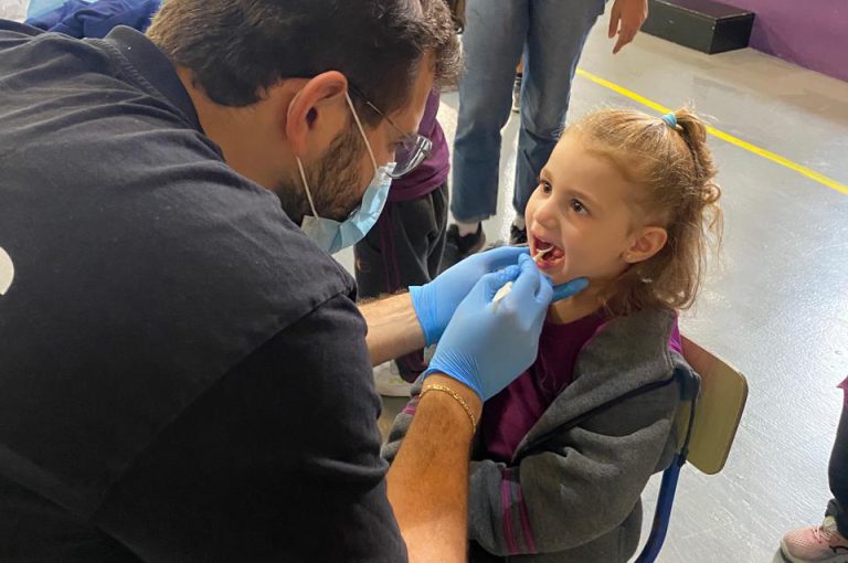 KG1 to Grade 1 students getting their teeth checked and learning basic dental care.