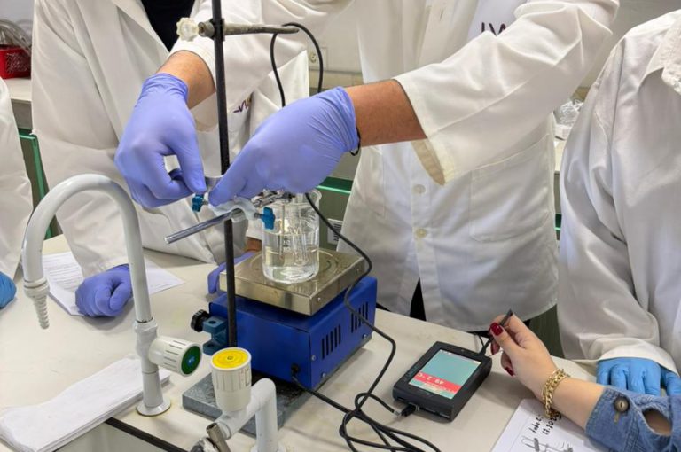 IB Year 1 students performing a lab experiment to find the molar mass of a volatile liquid