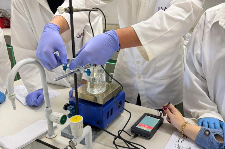 IB Year 1 students performing a lab experiment to find the molar mass of a volatile liquid