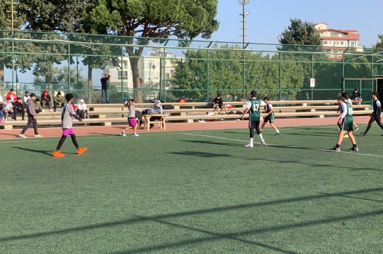 LWIS-AiS students playing football against St Jean Okaibe at the Lebanese Schools Tournament at NDU Zouk Mosbeh, showing teamwork and determination."