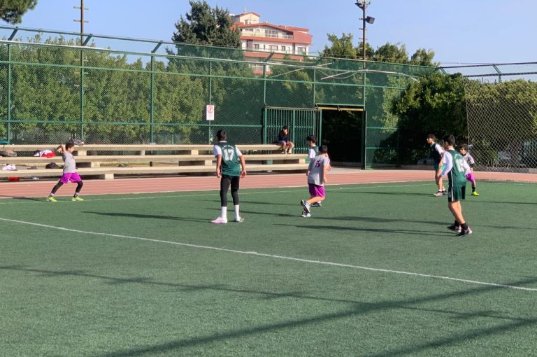 LWIS-AiS students playing football against St Jean Okaibe at the Lebanese Schools Tournament at NDU Zouk Mosbeh, showing teamwork and determination."