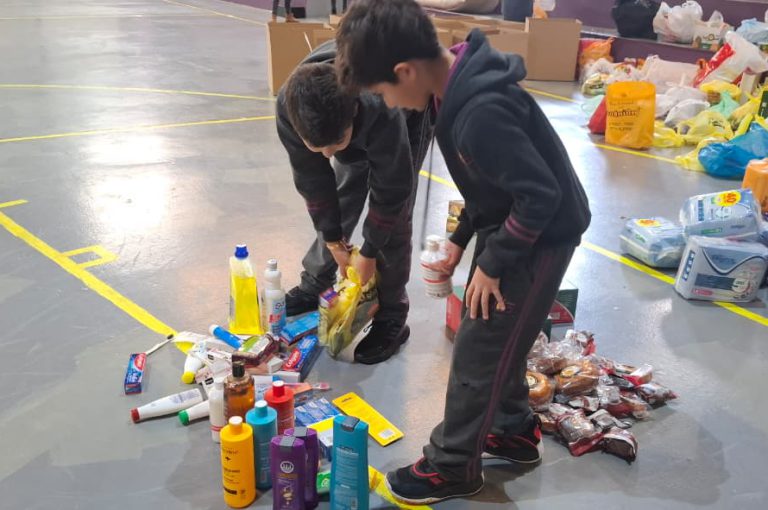 Students from Grades 2 to 5 at LWIS-AiS packing materials for the school’s Service-Learning program