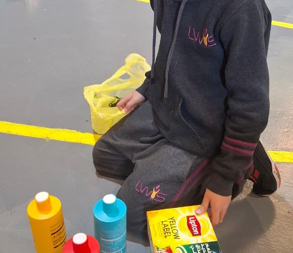 Students from Grades 2 to 5 at LWIS-AiS packing materials for the school’s Service-Learning program