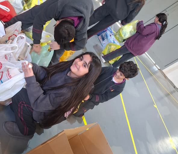 Students from Grades 2 to 5 at LWIS-AiS packing materials for the school’s Service-Learning program