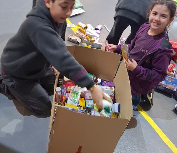 Students from Grades 2 to 5 at LWIS-AiS packing materials for the school’s Service-Learning program