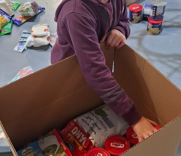 Students from Grades 2 to 5 at LWIS-AiS packing materials for the school’s Service-Learning program