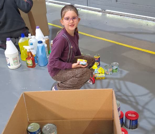 Students from Grades 2 to 5 at LWIS-AiS packing materials for the school’s Service-Learning program