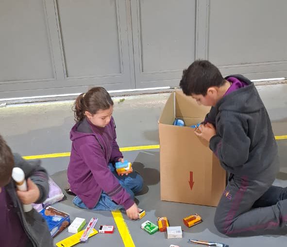 Students from Grades 2 to 5 at LWIS-AiS packing materials for the school’s Service-Learning program