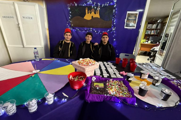 Students from the Middle and Senior School attending the HLSS Fair at the Upper Campus during the Arabic Night theme, with traditional decorations, cultural outfits, and festive activities.