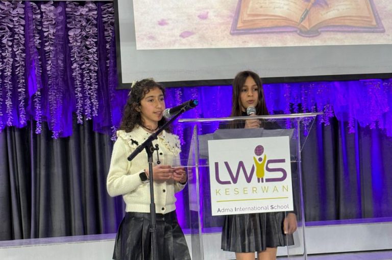 LWIS AIS students standing on stage, reciting poetry during Poetry Night event.