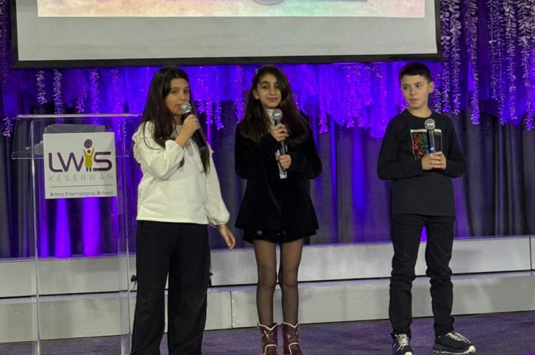 LWIS AIS students standing on stage, reciting poetry during Poetry Night event.