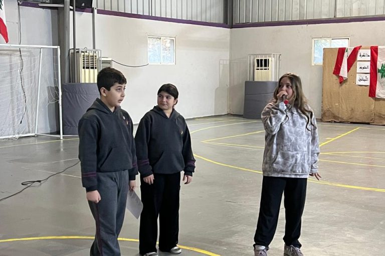 Lower School students performing on stage to honor teachers during the Teachers’ Day Assembly.