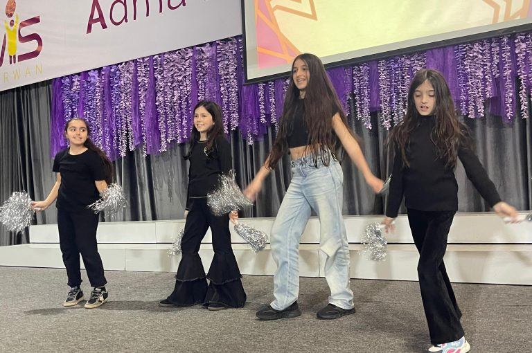 Lower School students performing various acts on stage during a talent show.