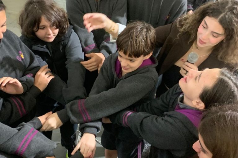 Representative from Step Ahead Sports School speaking to LWIS Adma International School students about mental health in sports, with interactive team-building activities promoting resilience and communication