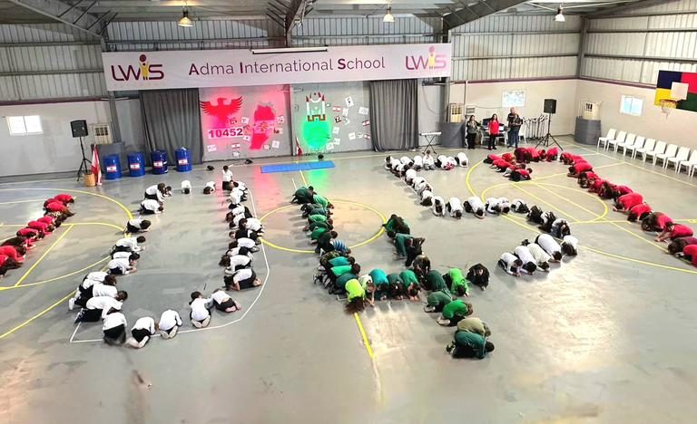 Students and teachers celebrating Independence Day at the lower campus in a festive and patriotic atmosphere