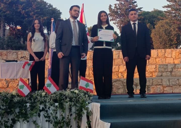 Jeya Geagea, Wendy Sleiman, and Chafic Chbat representing their school at the Future Debate Masters competition, achieving Top 4 in their first participation with a strong debate on population control, showcasing confidence, teamwork, and public speaking excellence.